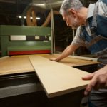 Attentive male person working at woodworking manufacture