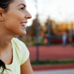 Beautiful female jogger tired after running